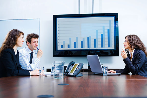 Businesspeople discussing in meeting room.