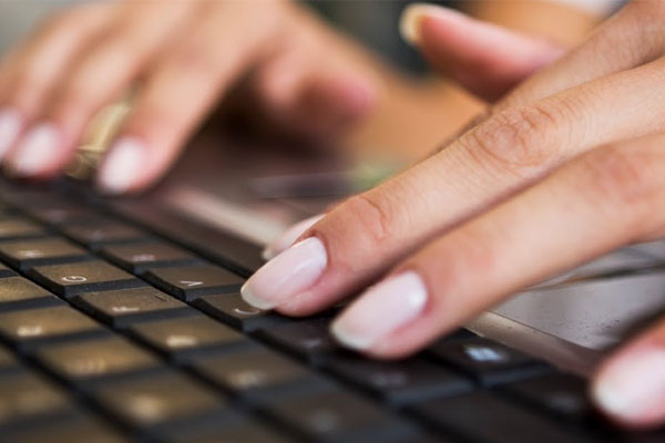 Woman typing on laptop